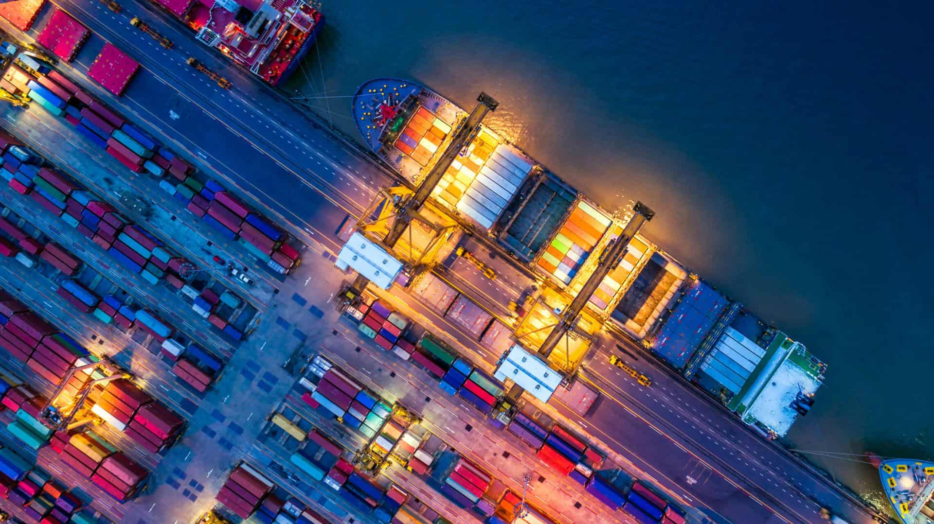 container ship in import export and business logistics, by crane, trade port, shipping cargo to harbor, aerial view from drone, international transportation, business logistics concept Shopbereich Zoll und Außenwirtschaft